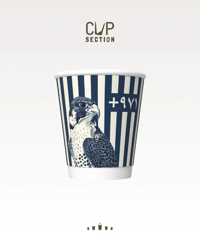 Cup Section paper cup with navy and cream stripes, a pen-drawn falcon and +971 in Arabic numerals.